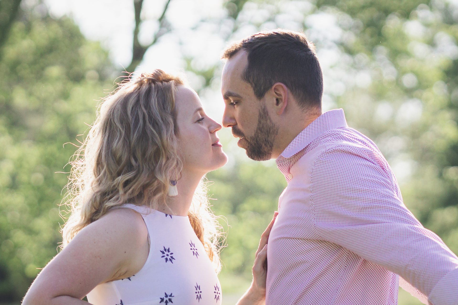 Backlit couple embracing in a golden field